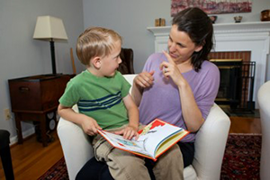 Mom reading a book to a child